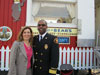 Los Angeles County Fire Chief Daryl Osby and Kim Sentovich, Walmart Senior Vice President for the Western Region stand in front of the Shakey Quaky Schoolhouse at an earthquake preparedness event in Duarte, California.