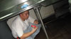 In the dishroom, Foodservice Worker Zachary Santos finds hidden candy under the stainless steel counter during the Shake Out drill.