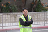 A Stanton City employee dressed in a reflective vest, blocks off the street in front of City Hall.